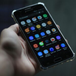 Close-up of a smartphone showcasing various mobile applications on its display.